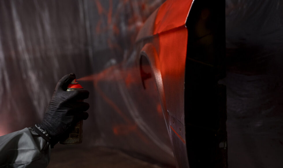 side-view-hand-spraying-powder-paint-door Salv Motor Paint Work